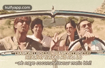 a group of people are driving a car on a desert road .