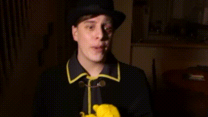 a man wearing a top hat and a yellow glove