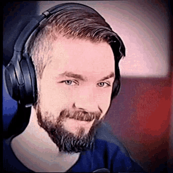 a man with a beard is wearing headphones