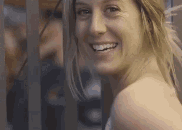 a close up of a woman 's face smiling