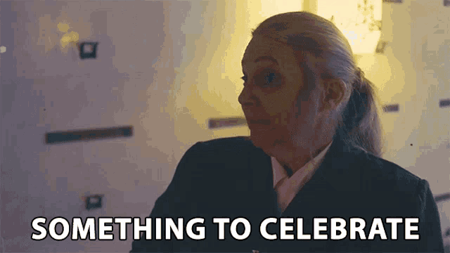 a woman says something to celebrate in front of a clock