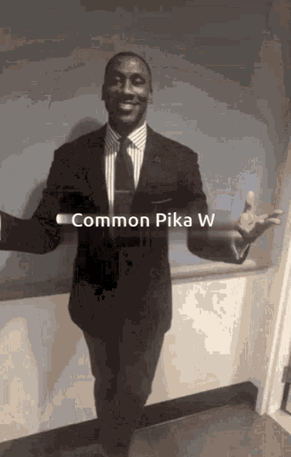 a man in a suit and tie is standing with his arms outstretched and the caption common pika w