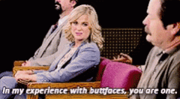 a group of people are sitting in chairs and one of them says in my experience with buttfaces you are one .