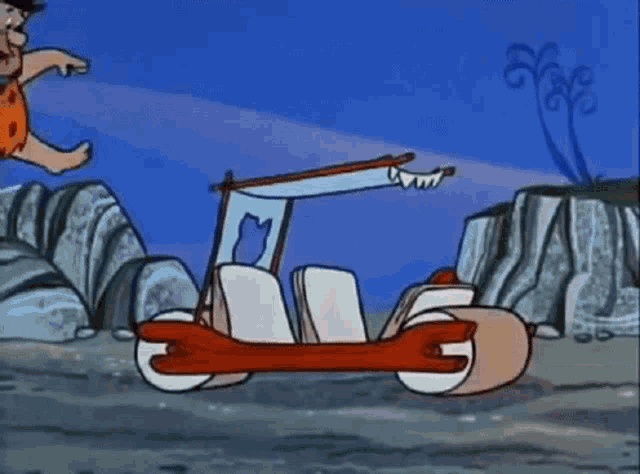 a cartoon of flintstone riding a car on a rocky hillside .