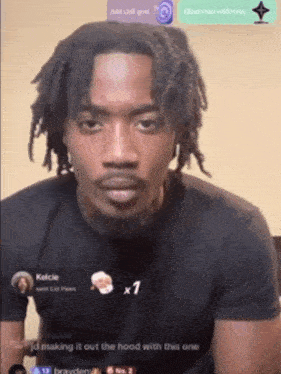 a man with dreadlocks is making a funny face in front of a screen that says making it out the hood with this one