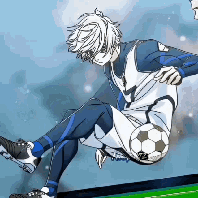 a boy in a blue and white uniform is kicking a soccer ball with his foot