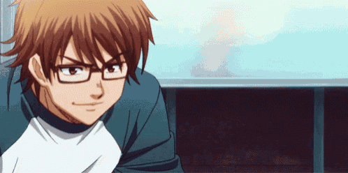 a man wearing glasses and a white shirt is smiling