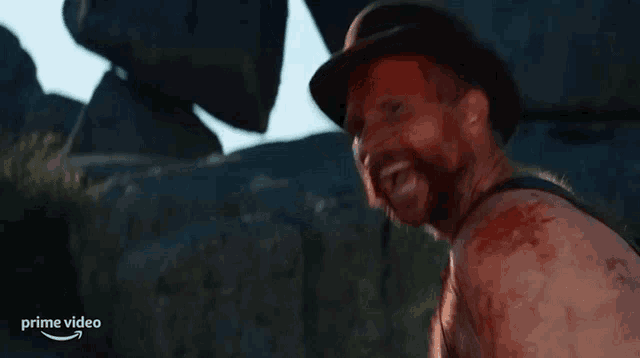 a man with blood on his face is wearing a hat and the word prime video is on the bottom right