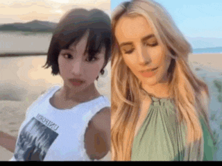 a woman with short hair and a woman with long hair are standing next to each other on the beach .
