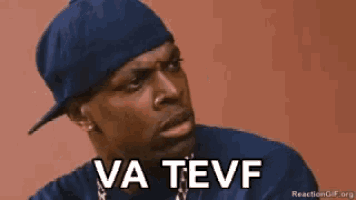 a man wearing a hat and a blue shirt says va tevf