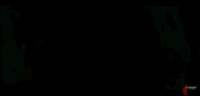 a close up of a person smoking a cigarette in a dark room .