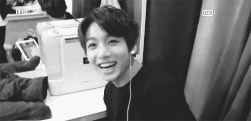 a black and white photo of a young man wearing headphones .
