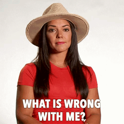 a woman wearing a hat and a red shirt is asking what is wrong with me