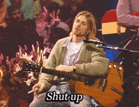 a man is smoking a cigarette while playing a guitar and the words shut up are visible