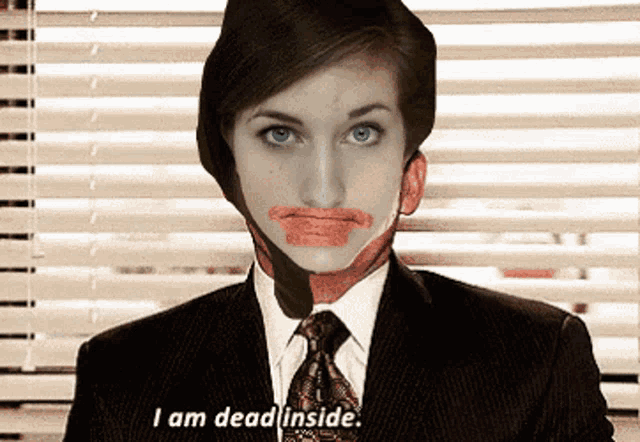 a woman in a suit and tie with lipstick on her face says i am dead inside