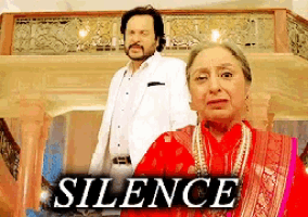 a man and a woman are standing next to each other in front of a sign that says " silence "