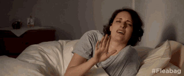 a woman is laying on a bed with the hashtag fleabag on the bottom right