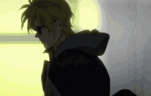 a man wearing sunglasses and a black jacket is standing in the dark .