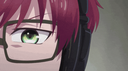 a close up of a person 's eye with green eyes and red hair