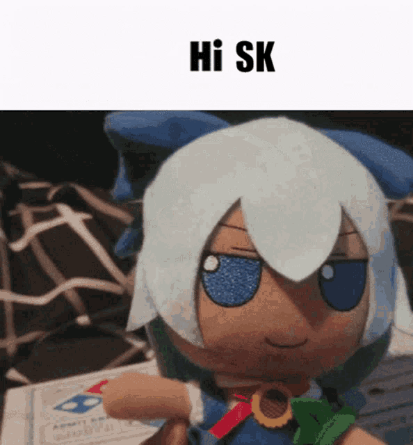 a stuffed doll with white hair and blue eyes is sitting on a table with the words hi sk above it