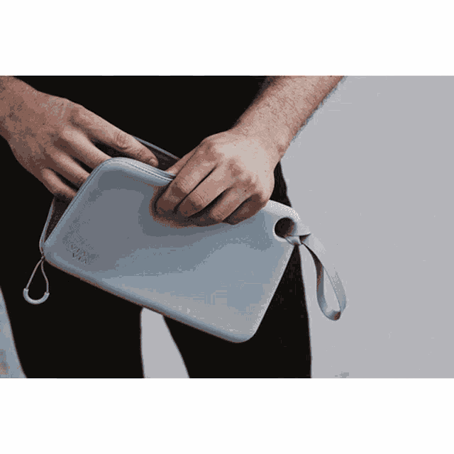 a person is holding a gray via via bag