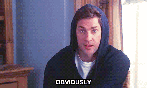a man in a hoodie is sitting in a chair with the word obviously above him .