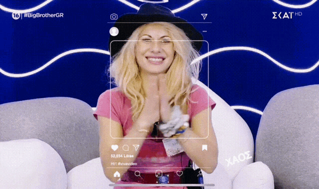 a woman sitting on a couch with a screen that says " big brother gr " on it