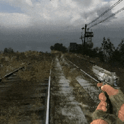 a person holding a gun on a train track in a video game