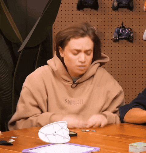 a woman wearing a hoodie that says smush on it