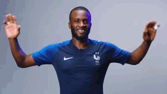 a man in a blue nike shirt with a rooster on the front