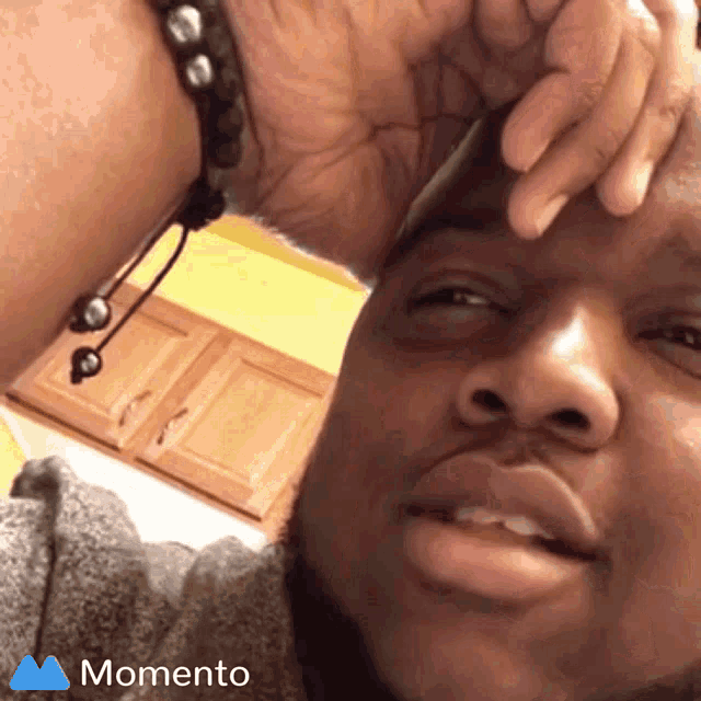 a close up of a man 's face with the words momento on the bottom