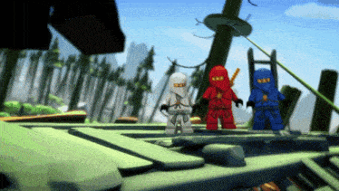 a group of lego ninjago figures are standing on a green surface