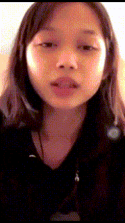 a close up of a girl 's face with headphones on her ears .