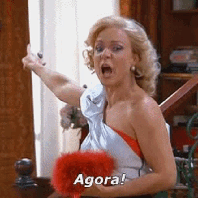 a woman in a white dress is holding a red fan and saying agora