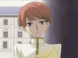 a young man with red hair is holding an envelope
