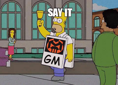 homer simpson holding a sign that says gm on it