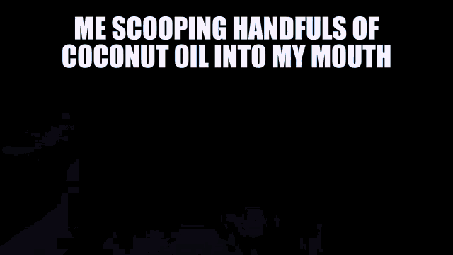 someone is scooping coconut oil into their mouth