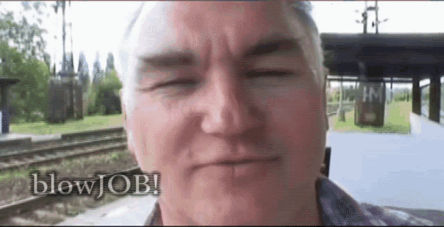 a close up of a man 's face with the words blow job written below him
