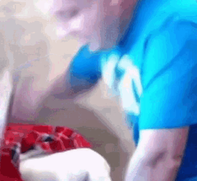 a man in a blue shirt with the number 12 on his chest