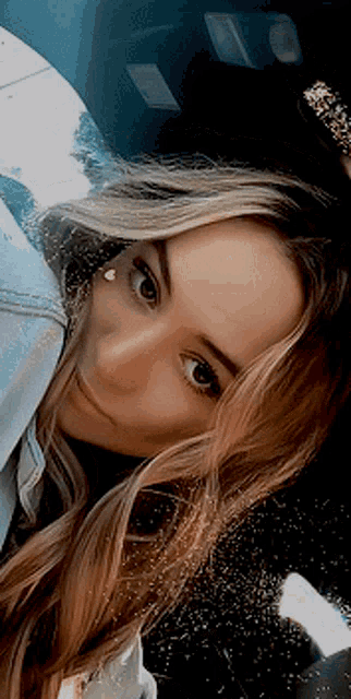 a close up of a woman 's face with long hair