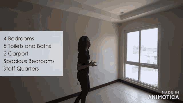 a woman stands in an empty room with a sign that says 4 bedrooms