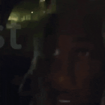 a close up of a person 's face with a flashlight shining on it .