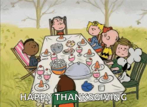 a cartoon of peanuts sitting around a table with the words happy thanksgiving