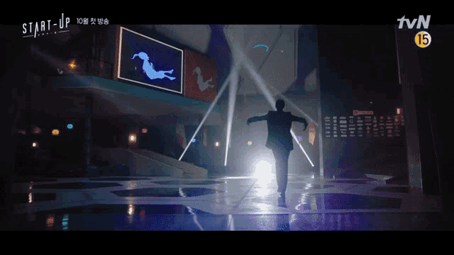 a man in a suit is running on a stage in front of a tvn logo