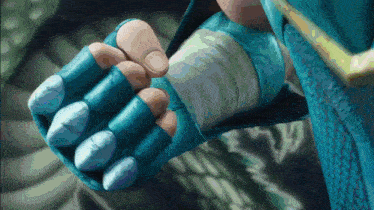 a close up of a person 's feet with blue gloves
