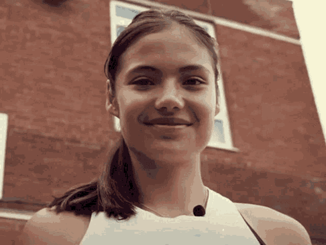 a close up of a woman 's face with a ponytail
