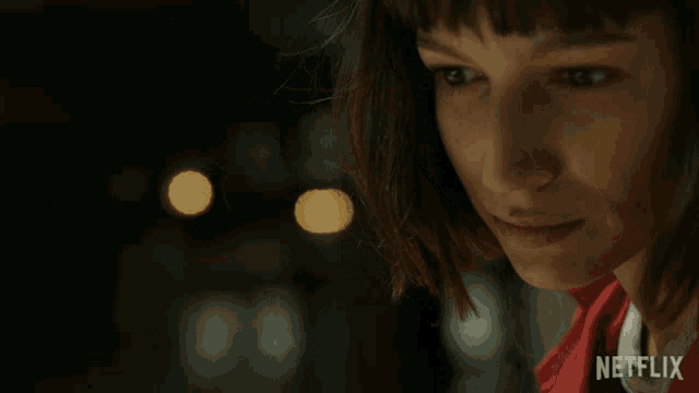a close up of a woman 's face with netflix written on the bottom