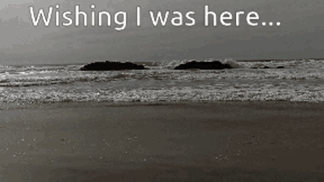 a beach with the words wishing i was here