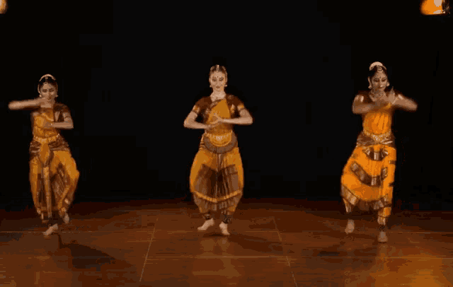 a group of dancers are jumping in the air