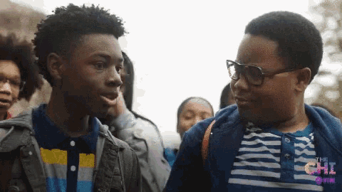 two boys are standing next to each other with the word the chi on the bottom